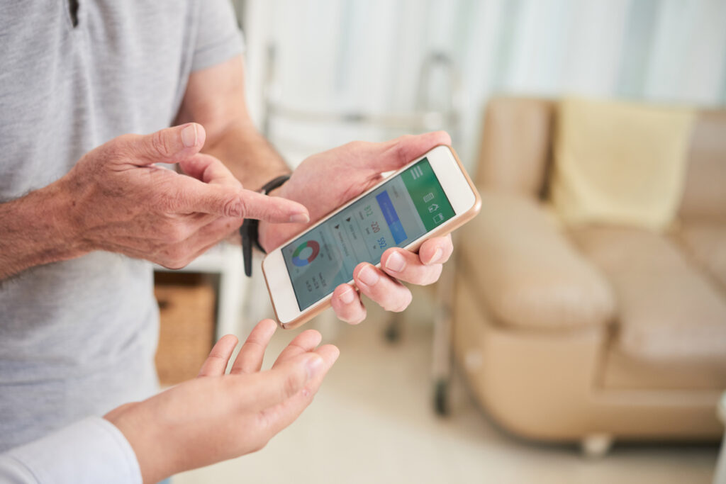 Two people look at health information on a smart phone.